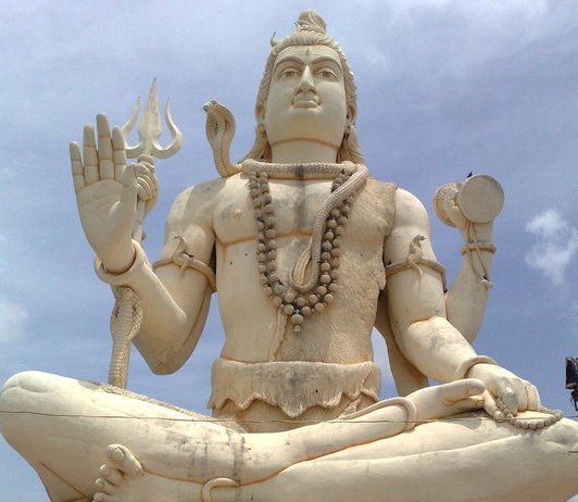 Lord Shiva in meditation pose greets devotees outside the temple